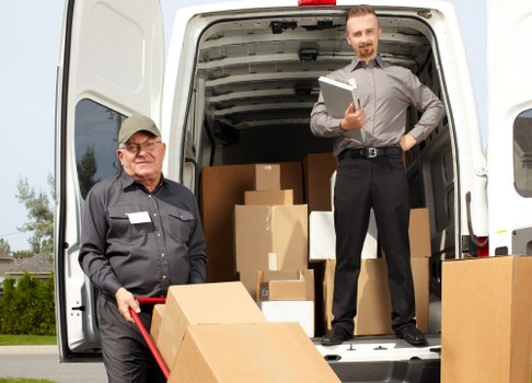 Man with a van loading furniture in Romford street