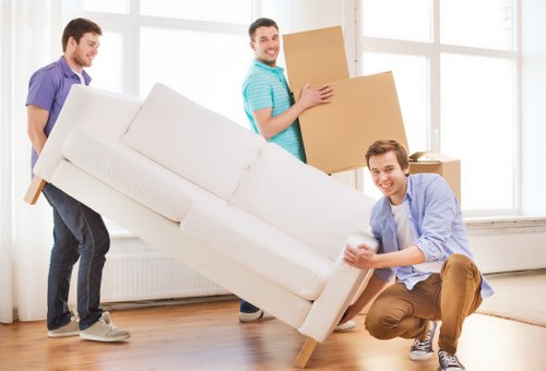 Office removals team handling desks and equipment in Romford