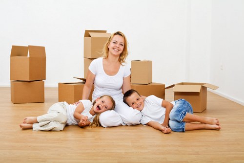 Professional movers handling furniture and boxes in a Romford property