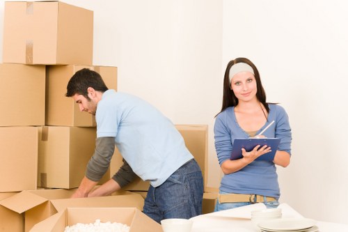 Boxes and furniture being loaded into a local removals van